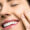A Woman Touching Her Face Smiling
