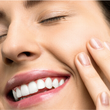 A Woman Touching Her Face Smiling