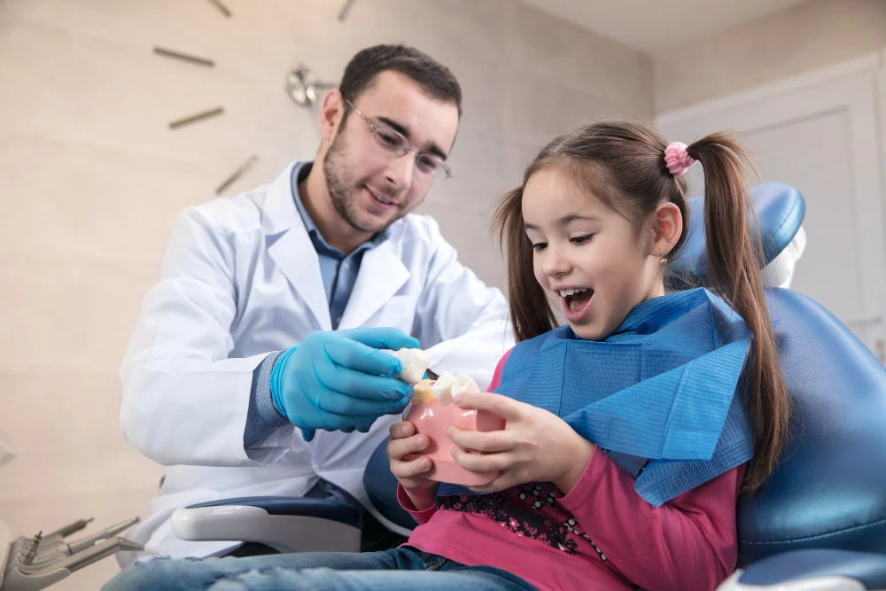 A Dentist giving something to his Child Patient