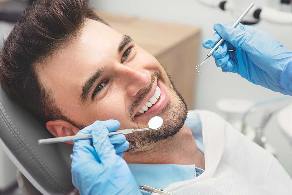 The Dentist Checking the Teeth of his Patient